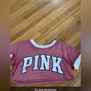 It’s pink branding croped stretchy shirt xs but could fit mostly anyone